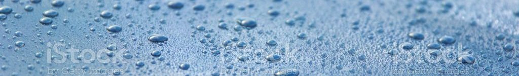 istockphoto-1165080552-1024×1024 The picture is showing the bonnet of washed and polished car. One can see the windshield and the windshield wipers in the background. Since it has rained before, the car is still wet. Due to the smooth surface the water tends to roll off and thus drops of water have accumulated. The mirror-like polished lacquer is reflecting the drops of water, the clouds and the sky. There is a shallow depth of field.