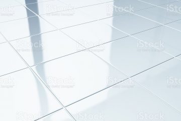 Clean white ceramic tiles on bathroom floor.